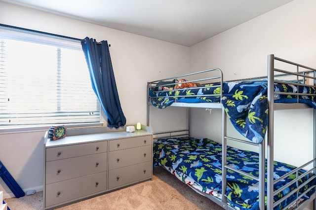 bedroom featuring light colored carpet