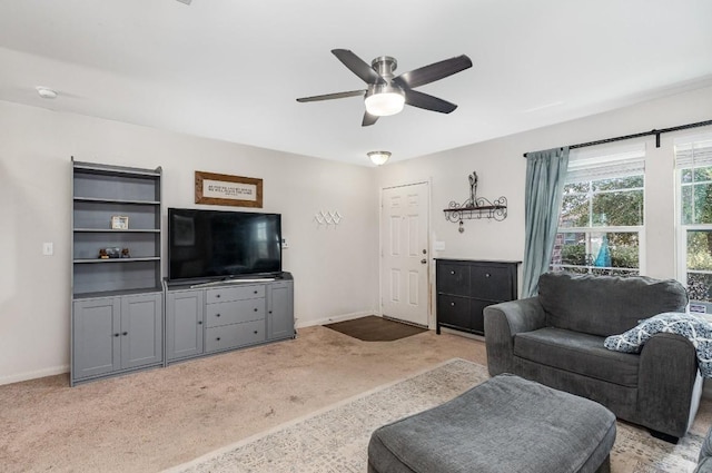 13708 Sierra Wind Ln, Elgin, TX 78621 - living area featuring light carpet, baseboards, and ceiling fan