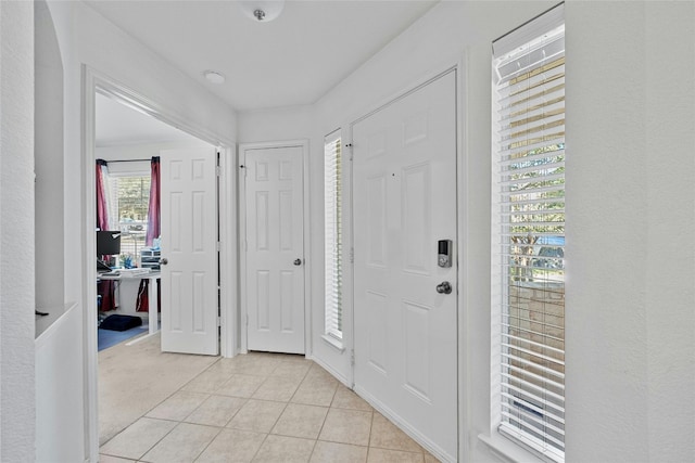 foyer entrance featuring light tile patterned floors