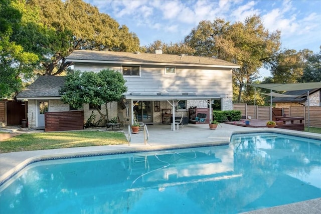 outdoor pool with a patio and fence