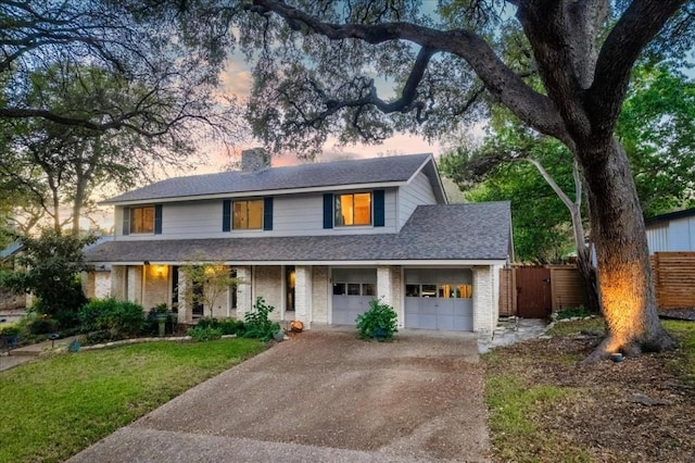view of front of property with aphalt driveway, fence, roof with shingles, a front lawn, and a chimney