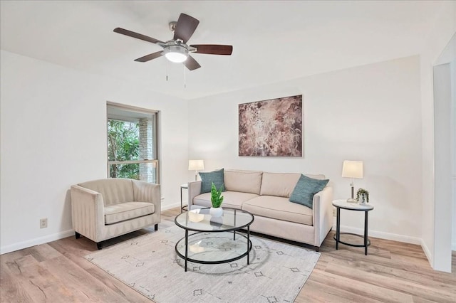 living room with wood finished floors, baseboards, and a ceiling fan