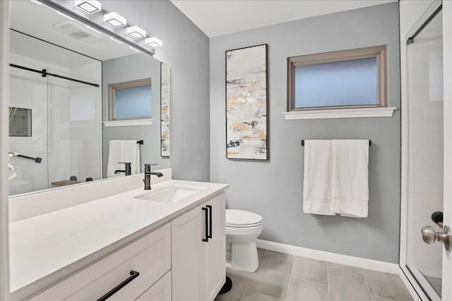 bathroom featuring vanity, toilet, baseboards, and a shower stall