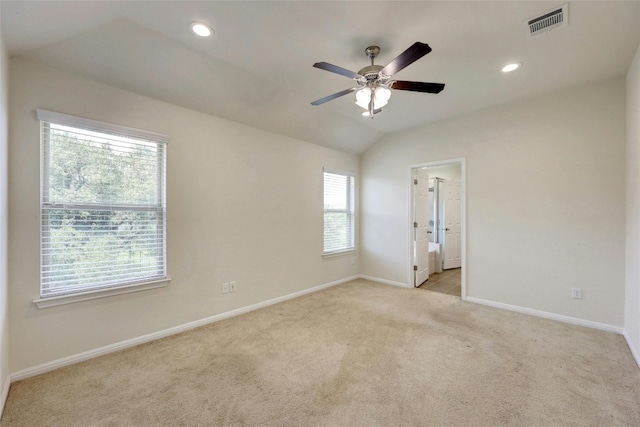 carpeted empty room featuring lofted ceiling and ceiling fan