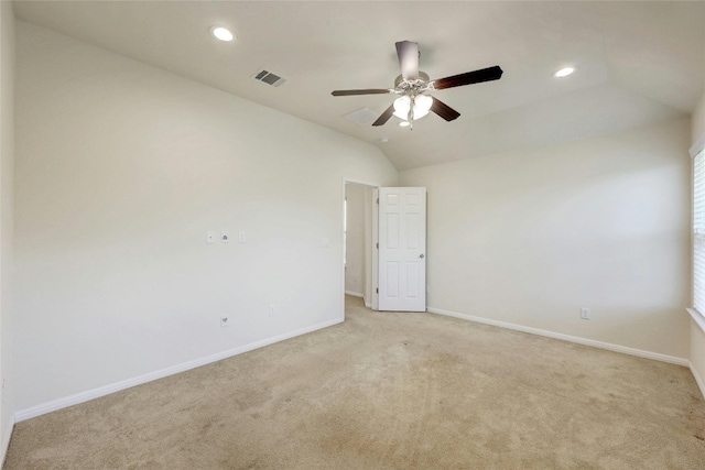 unfurnished room featuring ceiling fan, vaulted ceiling, and light colored carpet