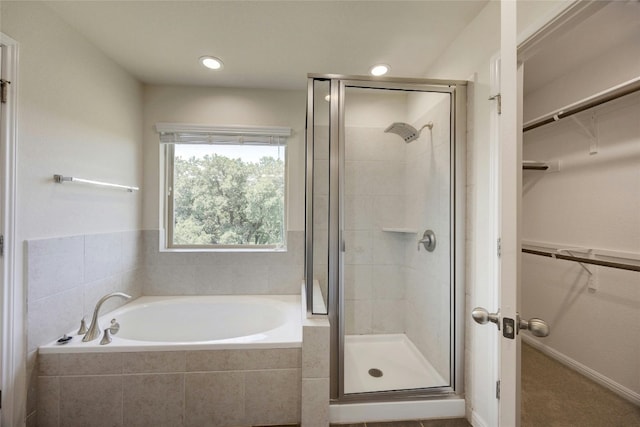 bathroom with separate shower and tub