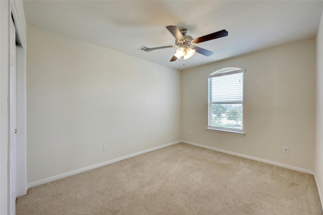 empty room featuring ceiling fan and light colored carpet