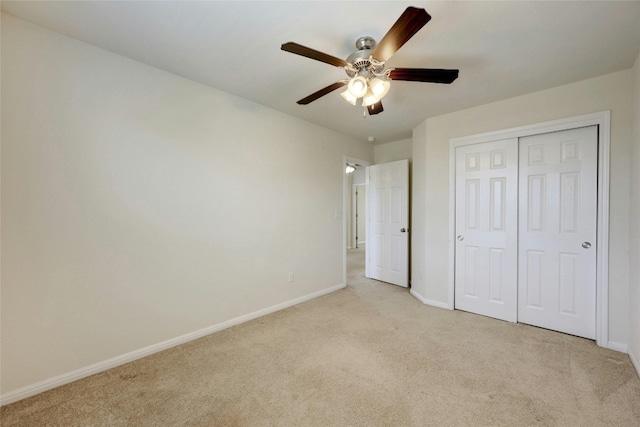 unfurnished bedroom featuring a closet, ceiling fan, and light colored carpet