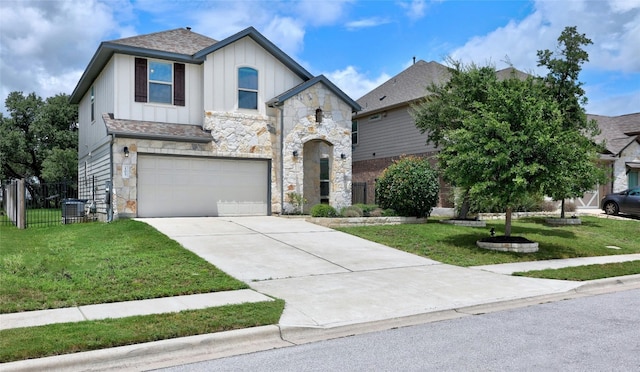 view of front of property with central AC, a garage, and a front lawn