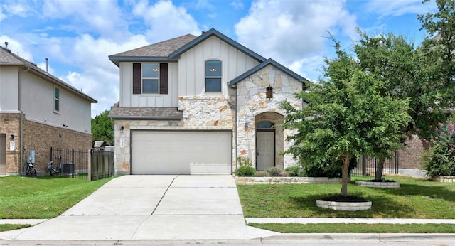 view of front of home with a front yard and a garage