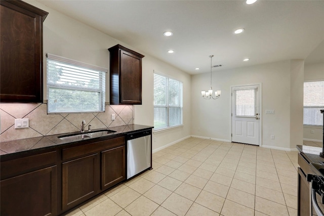 kitchen featuring dishwasher, backsplash, sink, decorative light fixtures, and a chandelier