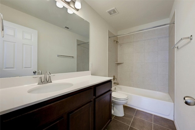 full bathroom with vanity, toilet, tiled shower / bath combo, and tile patterned flooring