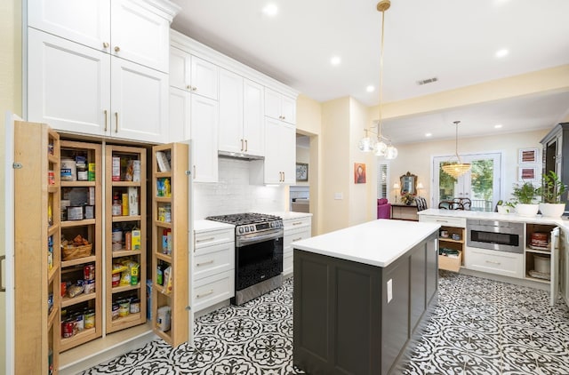 kitchen with a kitchen island, backsplash, hanging light fixtures, white cabinetry, and stainless steel appliances