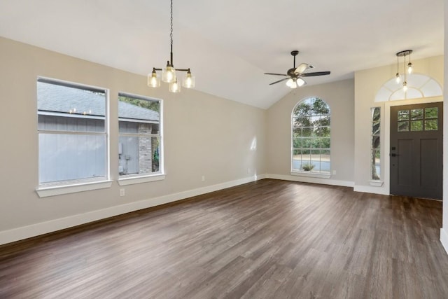 entryway featuring dark wood finished floors, vaulted ceiling, baseboards, and ceiling fan with notable chandelier