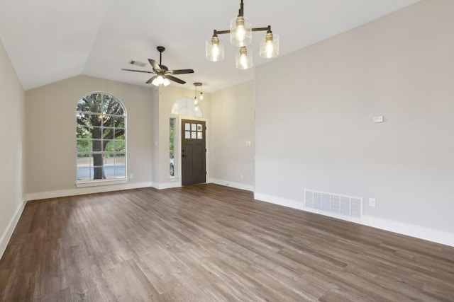 8222 Palace Pkwy, Austin, TX 78748 - unfurnished living room with wood finished floors, baseboards, a ceiling fan, vaulted ceiling, and a chandelier