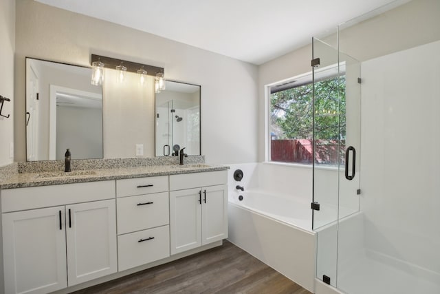 bathroom with vanity, hardwood / wood-style flooring, and shower with separate bathtub