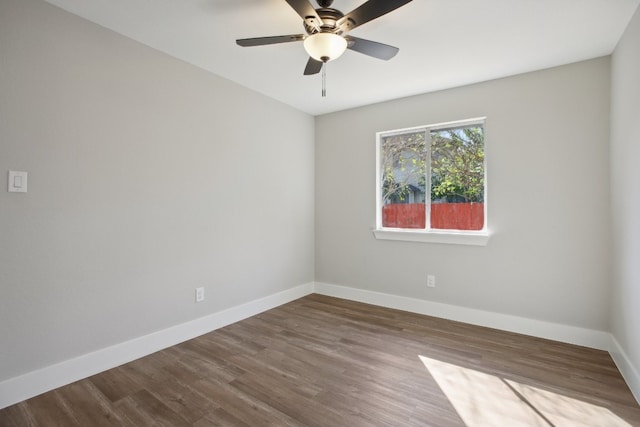 empty room with hardwood / wood-style floors and ceiling fan