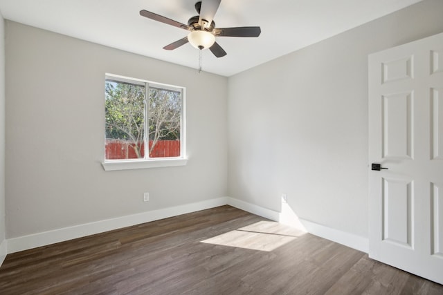 empty room with ceiling fan and dark hardwood / wood-style flooring