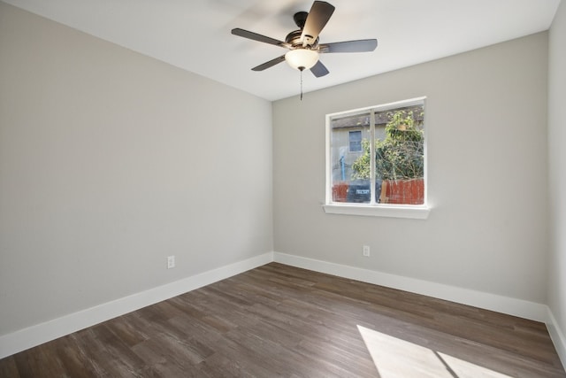 empty room with dark wood-type flooring and ceiling fan