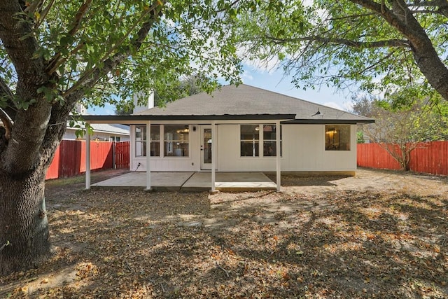 back of house featuring a patio area and a fenced backyard