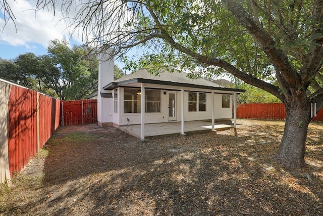 back of house with a patio