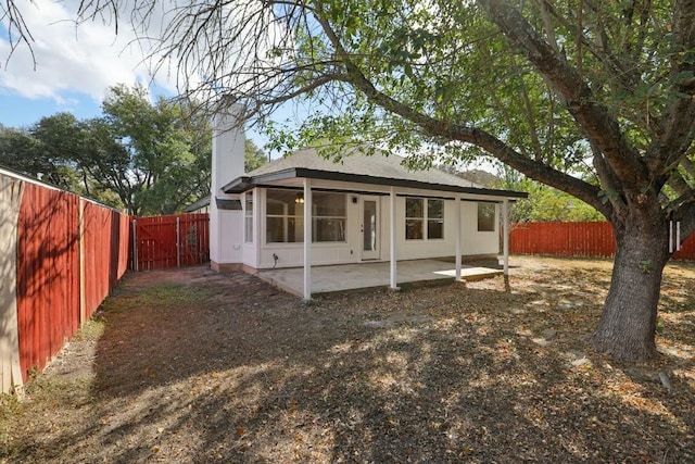 8222 Palace Pkwy, Austin, TX 78748 - view of front of house with a patio, a fenced backyard, roof with shingles, and a chimney