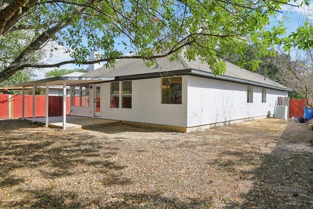 rear view of house featuring a patio area, fence, and central air condition unit