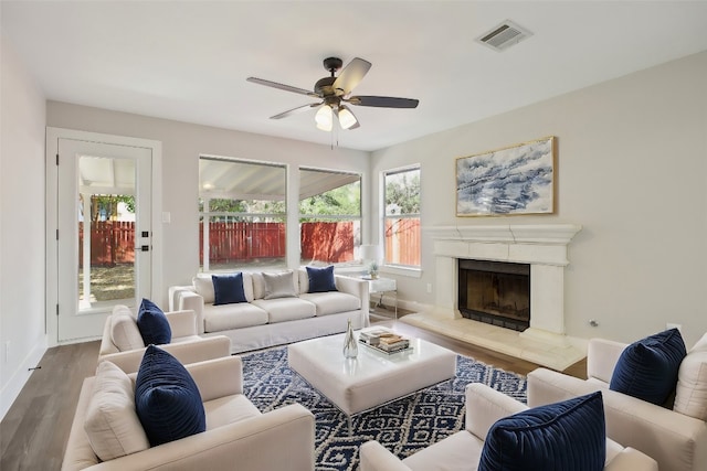 living room with wood-type flooring, a healthy amount of sunlight, and ceiling fan