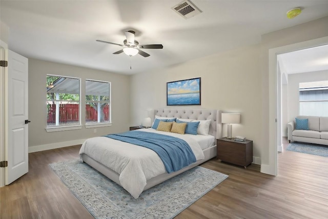 8222 Palace Pkwy, Austin, TX 78748 - bedroom with multiple windows, baseboards, wood finished floors, and a ceiling fan