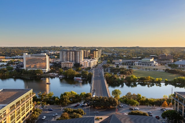 aerial view at dusk featuring a water view