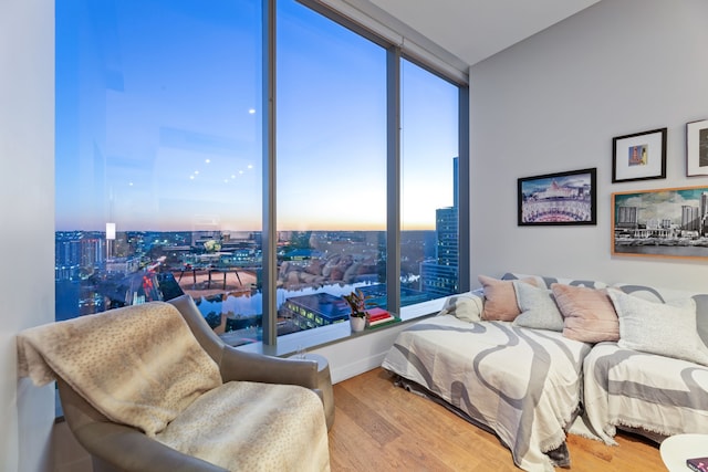 bedroom featuring floor to ceiling windows, hardwood / wood-style floors, and multiple windows