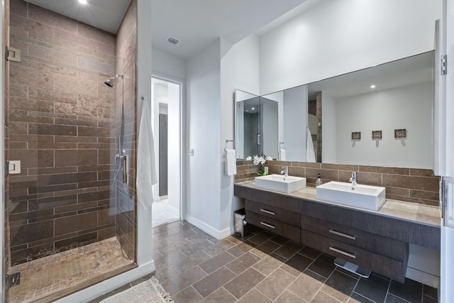 bathroom with a tile shower, backsplash, and vanity