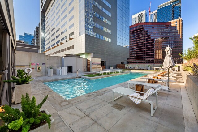 view of swimming pool with a patio and central AC unit