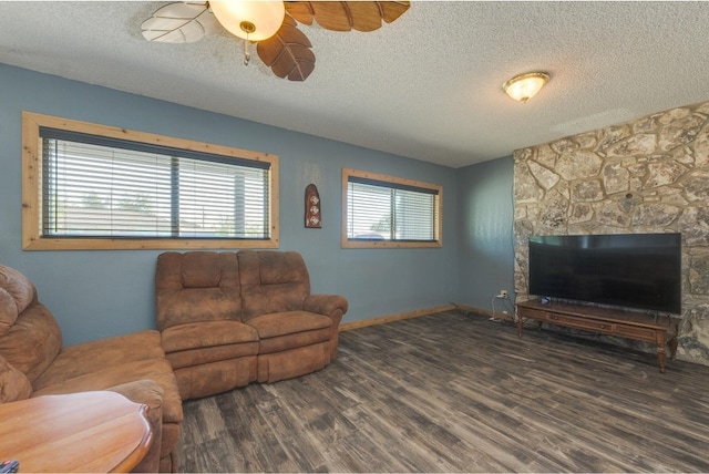 living room featuring dark hardwood / wood-style floors, a textured ceiling, and ceiling fan