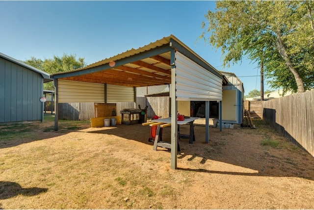 view of outbuilding with a lawn and a carport