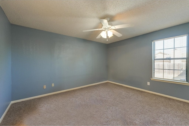 carpeted empty room with ceiling fan and a textured ceiling