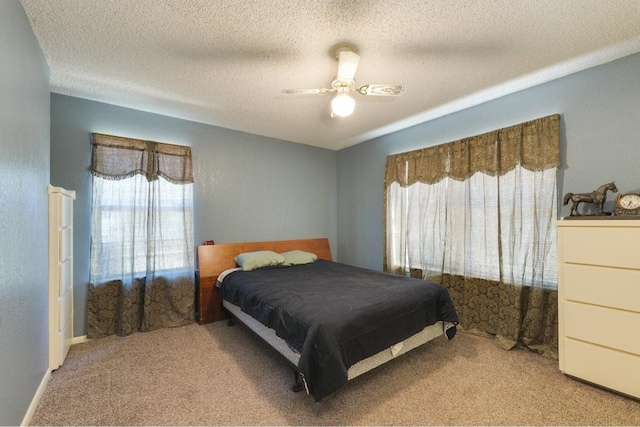 bedroom with light carpet, a textured ceiling, and ceiling fan