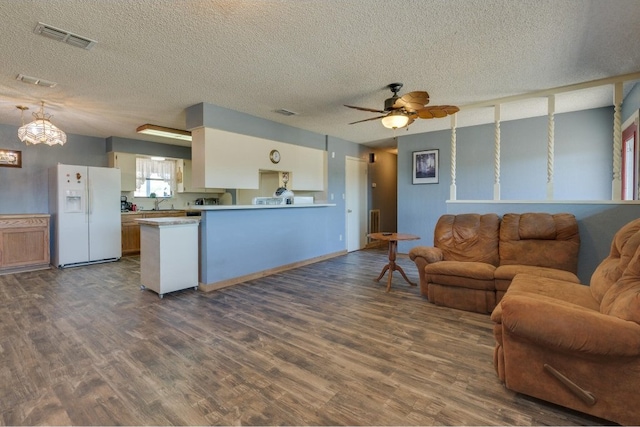 living room featuring sink, ceiling fan, a textured ceiling, and dark hardwood / wood-style flooring