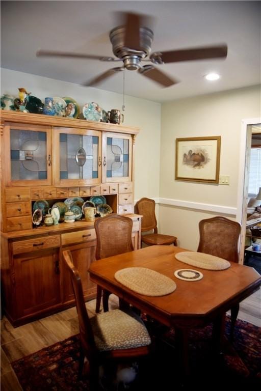 dining area with ceiling fan and hardwood / wood-style flooring