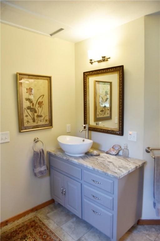 bathroom with tile patterned flooring and vanity