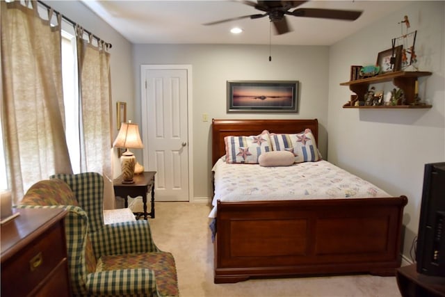 bedroom featuring ceiling fan and light colored carpet