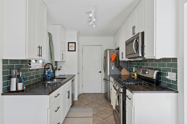 kitchen featuring white cabinetry, light tile patterned floors, stainless steel appliances, and sink