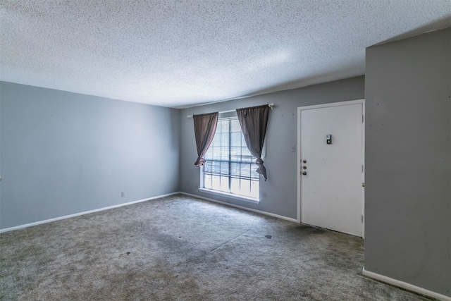 carpeted entrance foyer featuring a textured ceiling