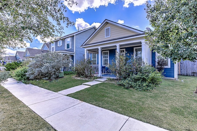 view of front of house featuring covered porch and a front lawn