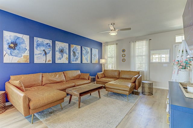 living room with ceiling fan and light hardwood / wood-style flooring