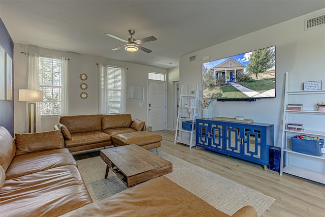 living room featuring light wood-type flooring and ceiling fan