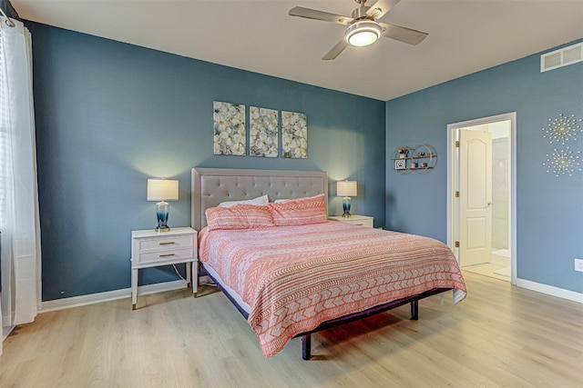 bedroom featuring light hardwood / wood-style flooring, ensuite bathroom, and ceiling fan