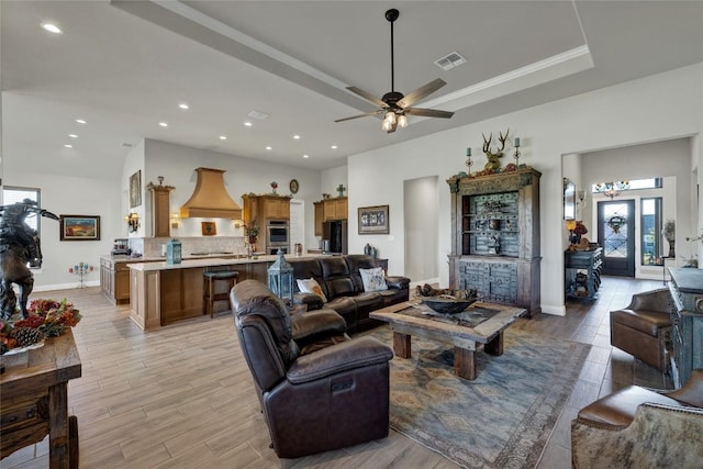 505 John Price St, Blanco, TX 78606 - living area with light wood-style flooring, a ceiling fan, recessed lighting, and a tray ceiling