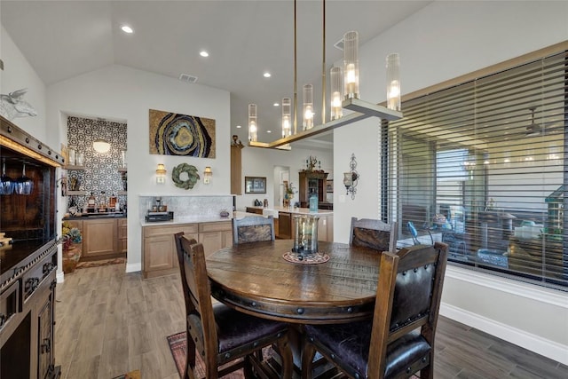 505 John Price St, Blanco, TX 78606 - dining space featuring light wood finished floors and vaulted ceiling