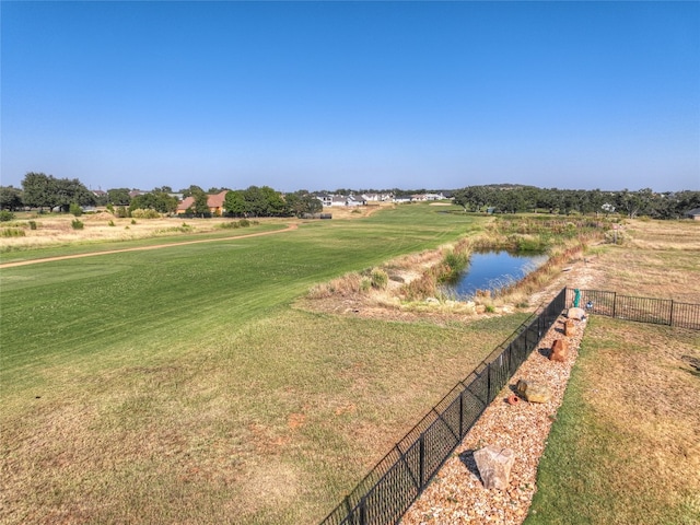 surrounding community with a yard and a water view